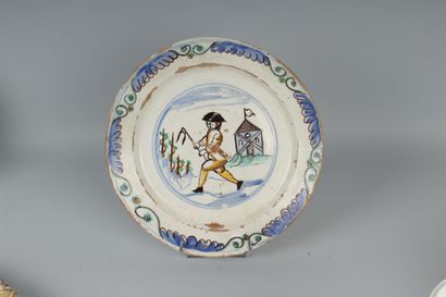 null SWITZERLAND 

Round glazed earthenware dish decorated in polychrome with a winegrower...