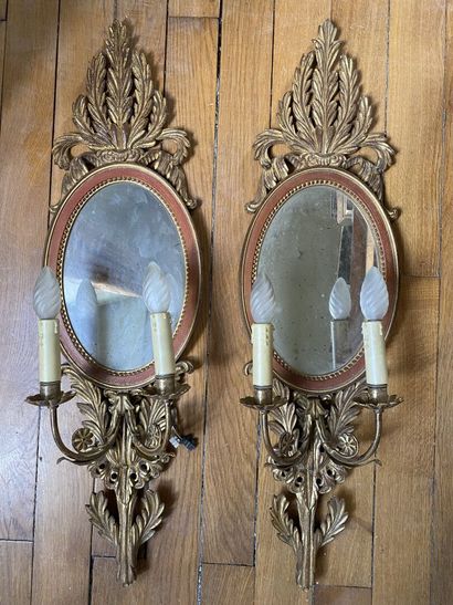 null PAIR OF REFLECTORS in gilded wood with two arms of light decorated with sprays...