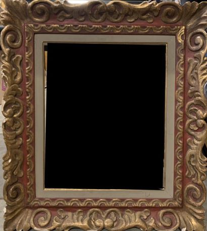 null Gilded and red carved wood frame decorated with volutes, scrolls and acanthus...