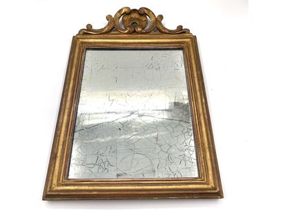 null Rectangular gilded wood mirror topped by a torn shell flanked by clasps.

19th...