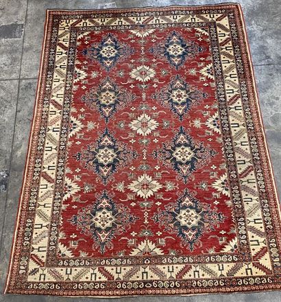 null Large woolen carpet decorated with medallions in flower on a rusty background,...