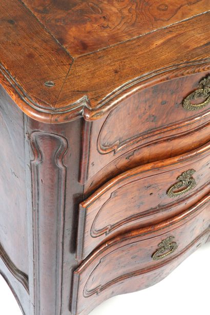 null A carved oak crossbow fronted COMMODE opening to three drawers in front, resting...