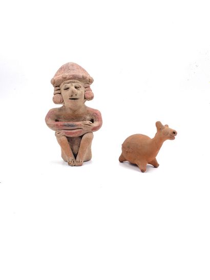 null Two polychrome terracotta statuettes, one showing a crouching man, the other...