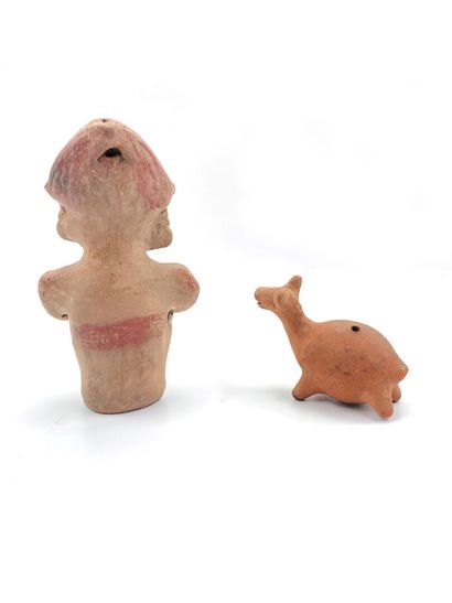 null Two polychrome terracotta statuettes, one showing a crouching man, the other...