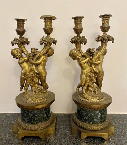 null PAIR OF CANDELABRES with two chased and gilded bronze light arms, representing...