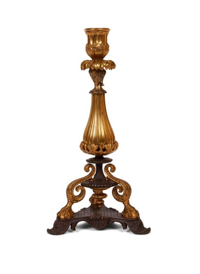 null FLAMBEAU in gilded and patinated bronze, the baluster resting on a tripod base...