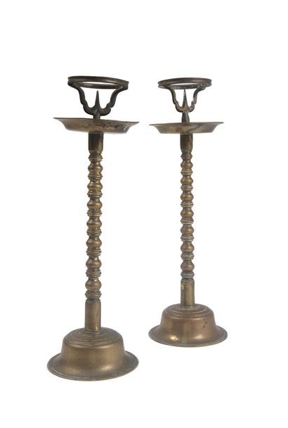 null Two brass pikesticks with superimposed baluster shafts resting on a circular...