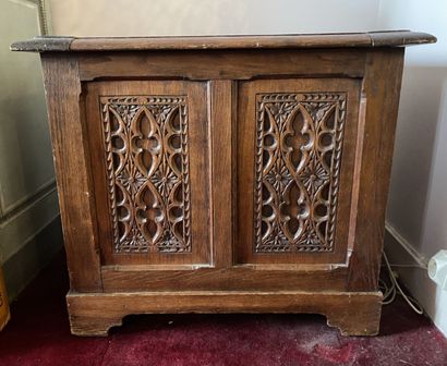 null CHEST in natural wood, molded and carved, the front with windows, opening to...