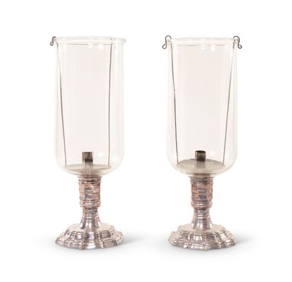 null Pair of silvered bronze and glass candle holders, the octagonal shaft resting...