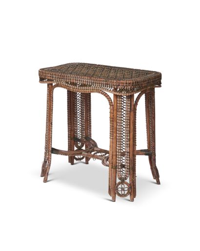 null Garden table in woven rattan resting on four legs joined by a strut. 
Work of...