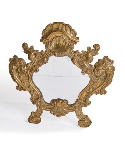 null Toilet mirror in embossed and silvered copper, of contoured form, with decoration...
