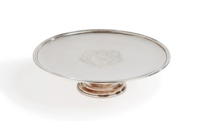 null Plated metal presentation dish of round form posing on molded pedestal, the...