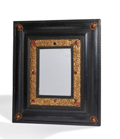null Mirror in blackened wood and gilded wood, decorated with stylized foliage and...