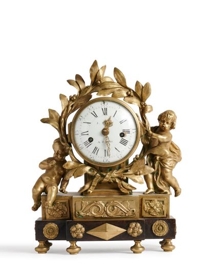 null Varnished bronze clock, decorated with two children in a frame of laurel leaves,
resting...