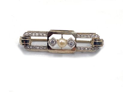 null A geometrically decorated gold brooch with a cultured pearl in the center between...