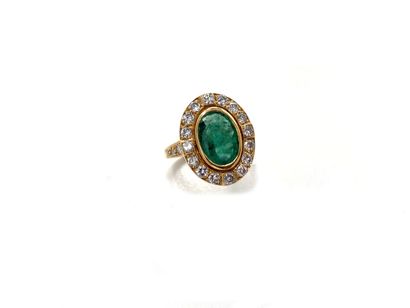 null Yellow gold ring 750 thousandths decorated in the center of an oval emerald...