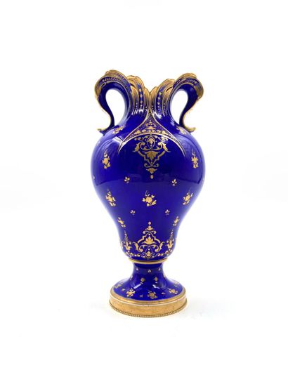 null Sevres
Porcelain ear vase decorated with flowers and scrolls in gold on a blue...