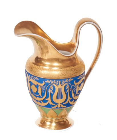 null Berlin
Porcelain milk jug with gold decoration of lyres and foliage on a blue...