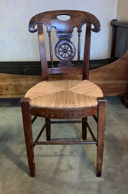null CHAIR in stained oak, the openwork and carved back decorated with flowers and...