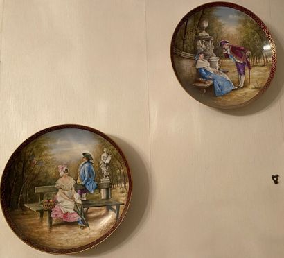 null Paire de plats en porcelaine à décor polychrome de scènes galantes, signée E.C....