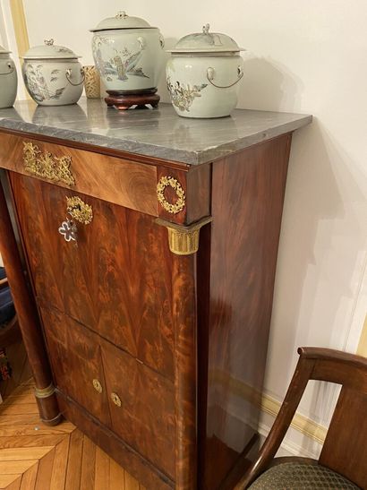 null A mahogany and mahogany veneer chest of drawers opening to a drawer in the upper...