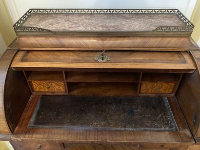 null Cylinder desk in veneer decorated with a trophy with musical instruments. The...