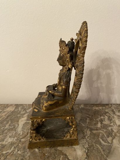 null CHINA
Statuette representing a seated Buddha in chased gilt bronze. 
20 x 10...