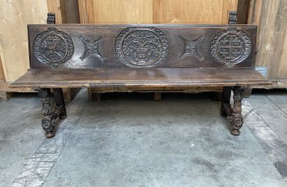 null Stained oak bench with carved vase and cross decoration, resting on four feet,...
