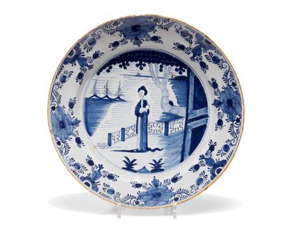 null DELFT
Round dish decorated in blue monochrome with a Chinese woman standing...