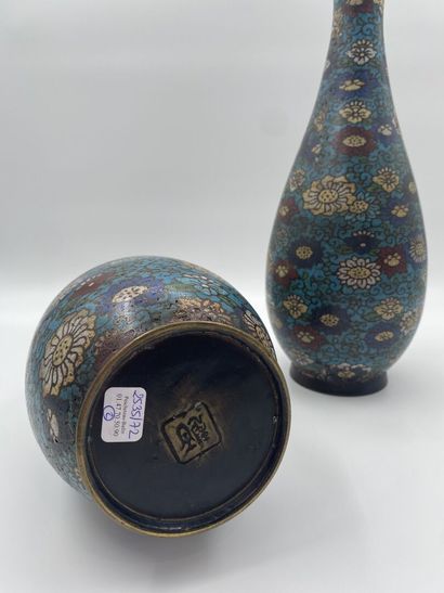 null JAPAN
A pair of cloisonné vases with polychrome decoration of flowers on a blue...