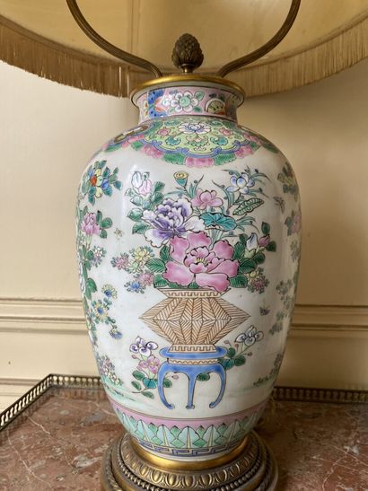 null CHINA 
Porcelain vase decorated in famille rose enamels with flowering vases,...