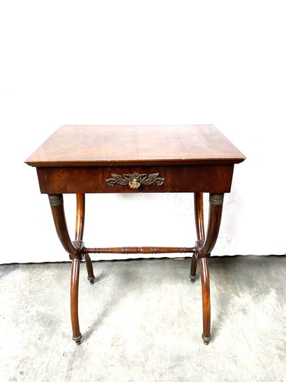 null A mahogany and mahogany veneer TABLE TRAVAILLEUSE opening with a drawer in the...