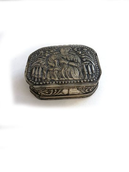 null Rectangular silver box with cut sides, the lid with engraved and repoussé decoration...
