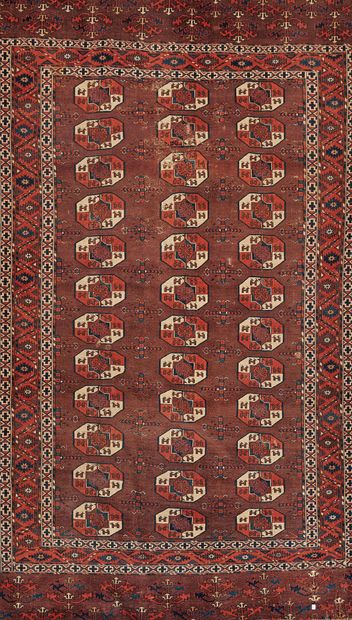 null TURKMEN 
Carpet decorated with guhls on a wine bed background, star borders...