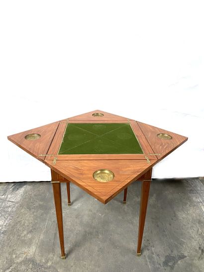 null GAME TABLE in marquetry, the top opening to four leaves on a tray, a drawer...