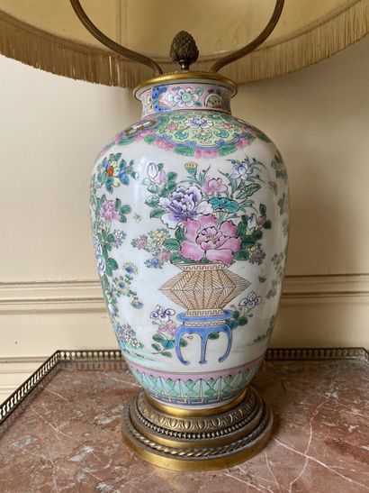 null CHINA 
Porcelain vase decorated in famille rose enamels with flowering vases,...