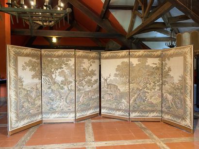 null TWO three-leaf wooden folding screens upholstered in Aubusson-style petit point...