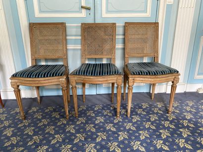 null THREE CHAIRS in molded and carved natural wood, the straight back and caned...