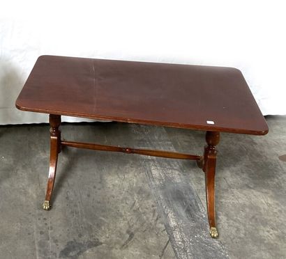 null A LOW TABLE in varnished wood with X-shaped legs joined by a brace. 
 50 x 90...