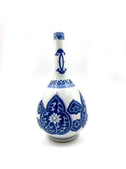null China
Porcelain bottle-shaped vase decorated in blue underglaze with lambrequins...