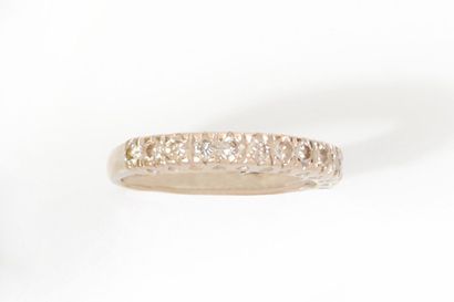 null Wedding band in 750 thousandths white gold with a central line of thirteen round...
