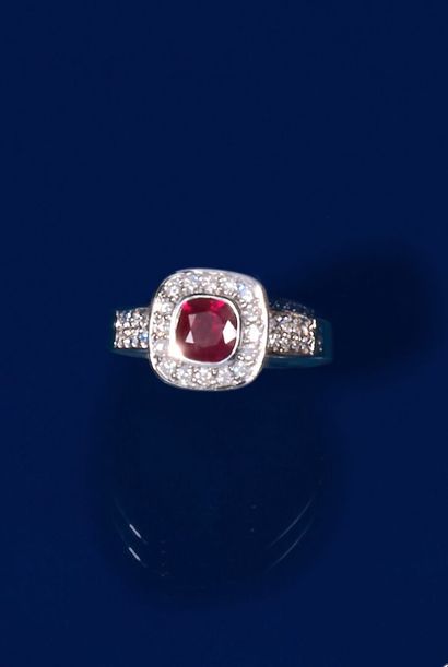 null 750 thousandths white gold ring set in the center with a cushion ruby in a setting...