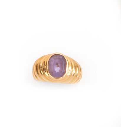 null Ring in 750 thousandths yellow gold, center-set with an oval amethyst, the setting...