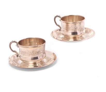 null A pair of chocolate cups and saucers in 950 thousandths silver, decorated with...