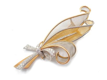 null 750 thousandths yellow gold and 850 thousandths platinum lapel clip with foliage...