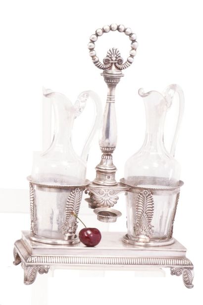 null 950-milliliter silver winder stand on a rectangular four-legged base decorated...