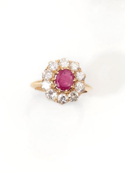 null Ring in 750 thousandths yellow gold, center set with a treated ruby in a setting...