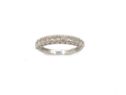null Wedding band in 750 thousandths white gold with a central line of thirteen round...