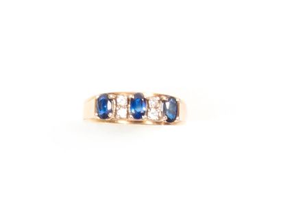 null Ring in 585 thousandths yellow gold set in the center with a line of three sapphires...