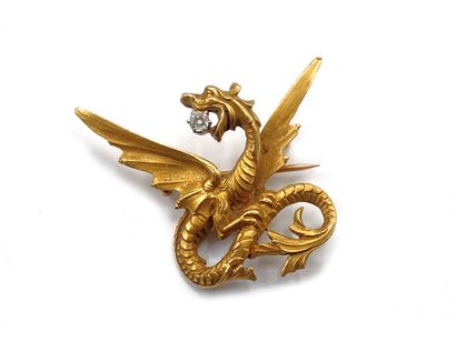 null 750 thousandth yellow gold engraved and diamond brooch featuring a dragon holding...